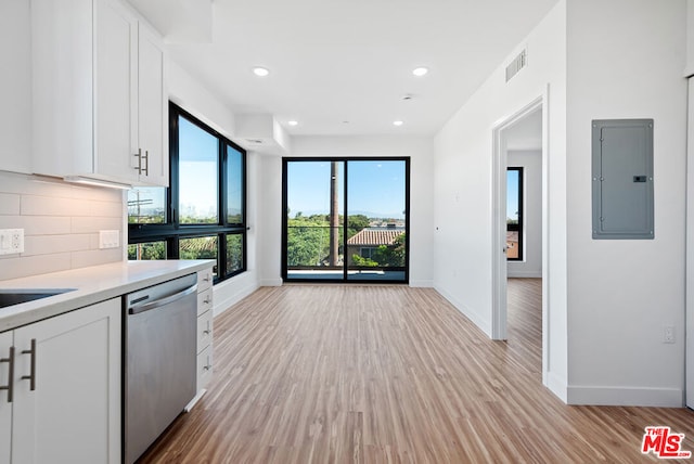 kitchen with dishwasher, electric panel, decorative backsplash, light hardwood / wood-style floors, and white cabinetry