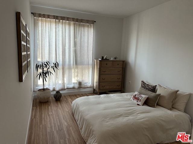 bedroom with wood-type flooring