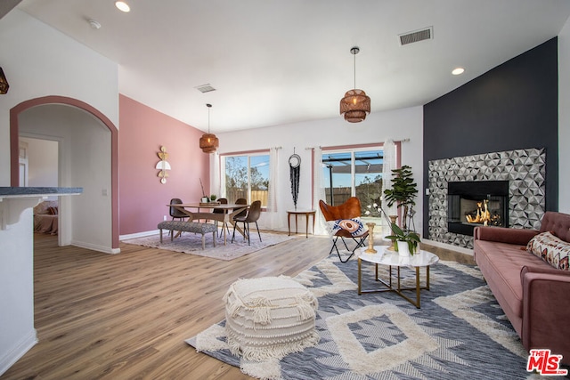 living room featuring hardwood / wood-style floors and a stone fireplace