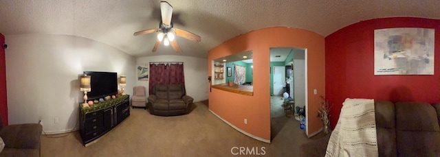 living room with ceiling fan, a textured ceiling, and vaulted ceiling