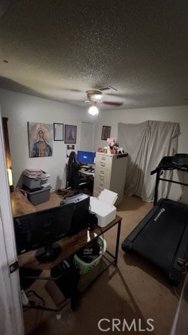 carpeted office space with ceiling fan and a textured ceiling