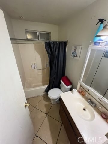 bathroom with vanity, tile patterned flooring, toilet, and walk in shower