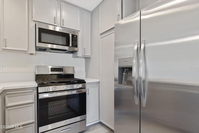 kitchen with appliances with stainless steel finishes and white cabinetry