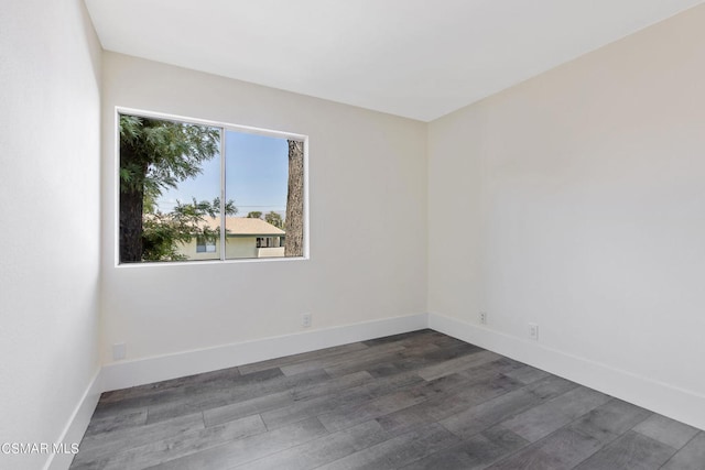 unfurnished room with dark hardwood / wood-style flooring