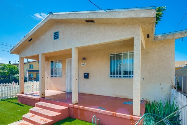 back of property with a porch