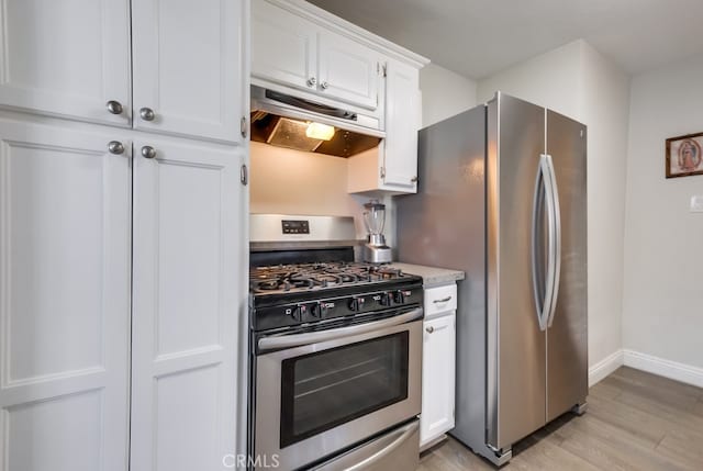 kitchen featuring white cabinets, stainless steel appliances, and light hardwood / wood-style floors