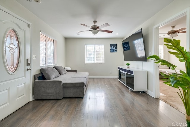 living room with hardwood / wood-style flooring, plenty of natural light, and ceiling fan