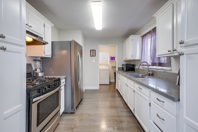 kitchen featuring washer / clothes dryer, white cabinetry, light hardwood / wood-style floors, and stainless steel range with gas stovetop