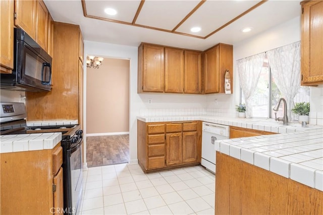 kitchen featuring dishwasher, tile counters, light tile patterned floors, and stainless steel range with gas stovetop