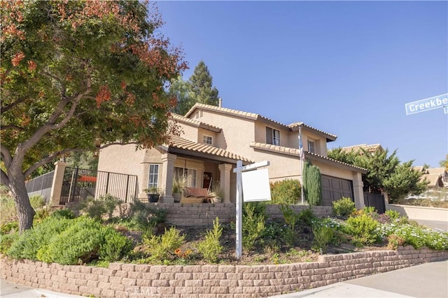 mediterranean / spanish home featuring a garage