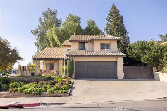 mediterranean / spanish-style house with a garage