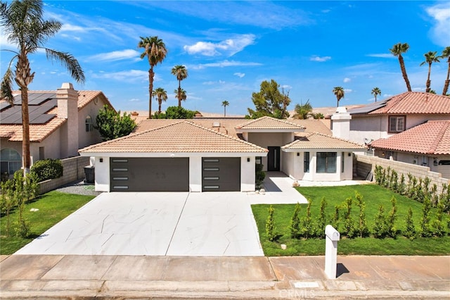 mediterranean / spanish-style house with a front yard and a garage