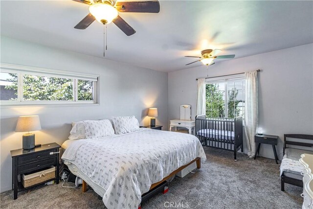 bedroom with multiple windows, carpet, and ceiling fan