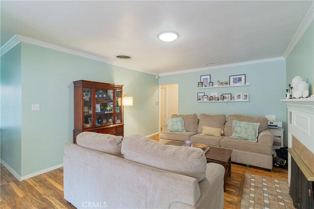 living room featuring hardwood / wood-style flooring and ornamental molding