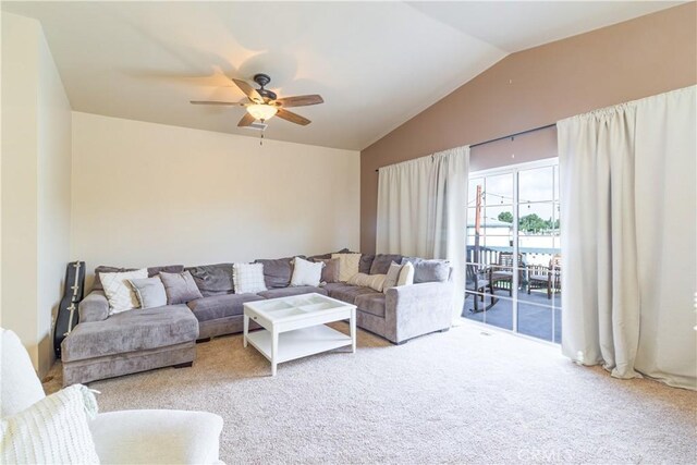 carpeted living room featuring ceiling fan and vaulted ceiling