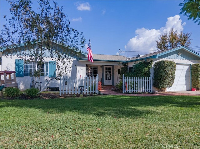 ranch-style house featuring a garage and a front lawn