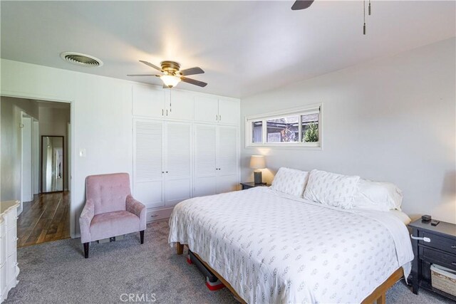 bedroom featuring ceiling fan, a closet, and hardwood / wood-style flooring