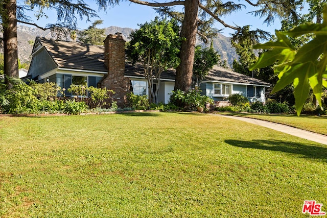 view of front of home featuring a mountain view and a front yard