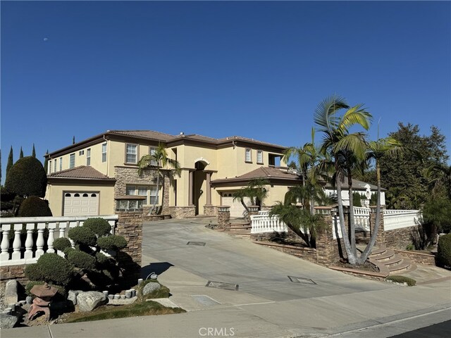 mediterranean / spanish-style home with a garage