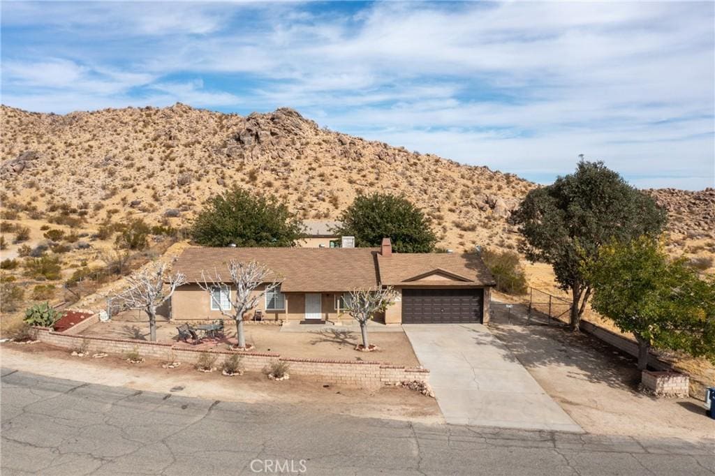 ranch-style home featuring a mountain view and a garage