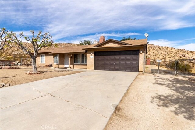 single story home featuring a mountain view and a garage