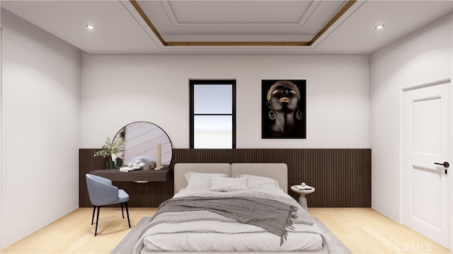 bedroom with light hardwood / wood-style flooring and a raised ceiling