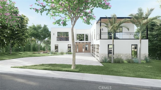 view of front facade featuring a balcony and a front yard