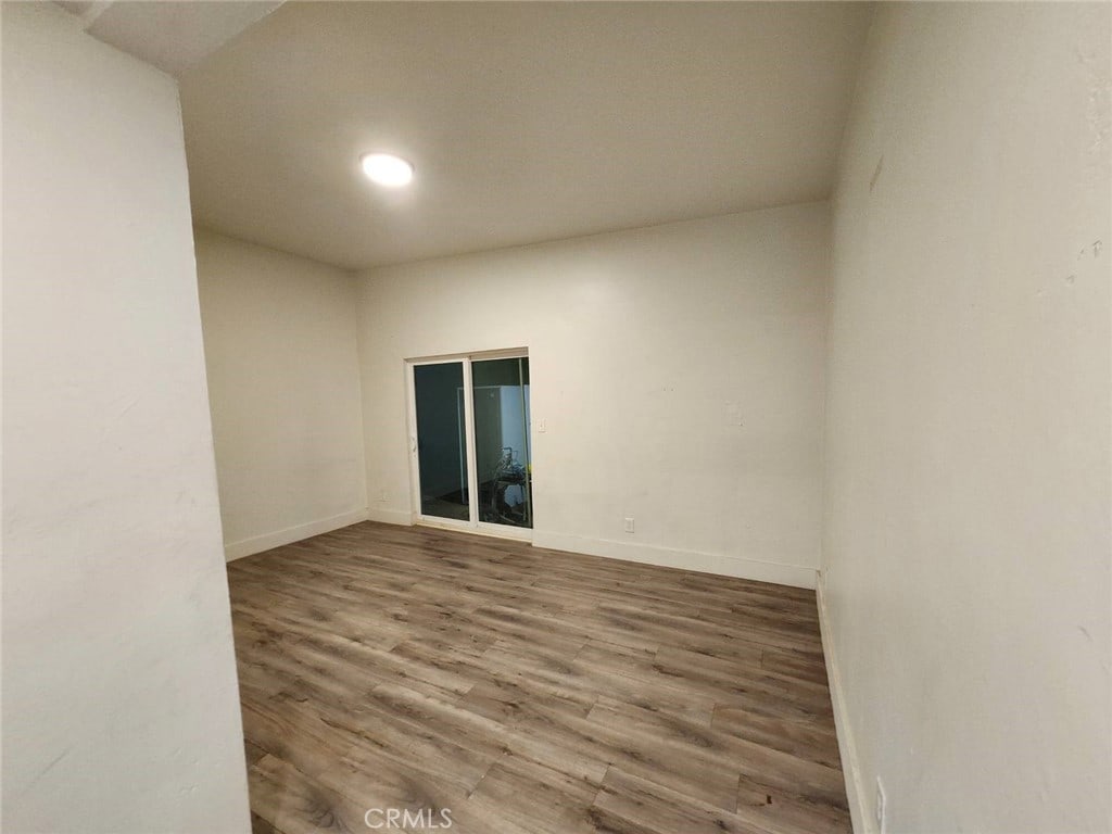 empty room with hardwood / wood-style floors