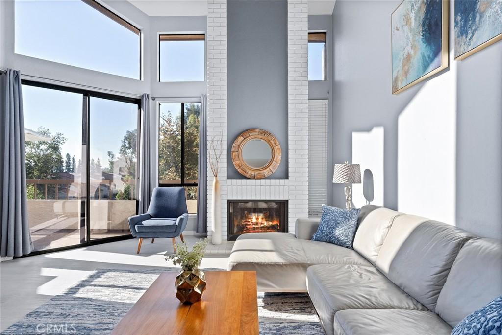 living room with a fireplace and a healthy amount of sunlight