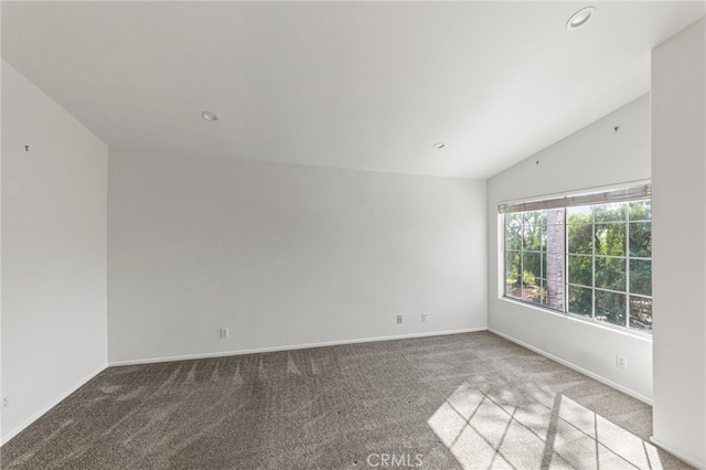 empty room with lofted ceiling and carpet