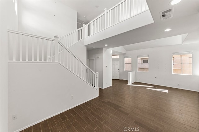 unfurnished living room with dark hardwood / wood-style flooring