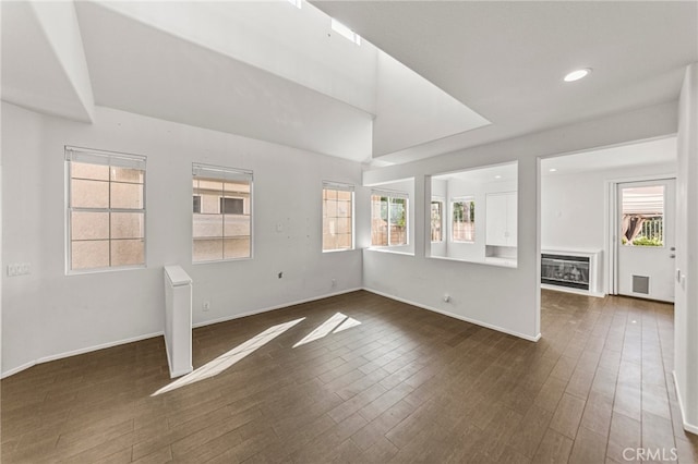 unfurnished living room featuring dark wood-type flooring