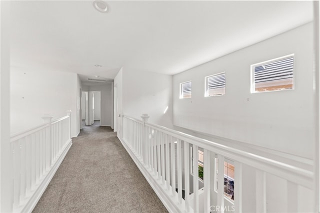 hall with light colored carpet