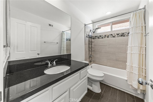 full bathroom with vanity, toilet, and shower / bath combo