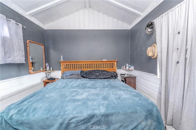 bedroom with lofted ceiling with beams