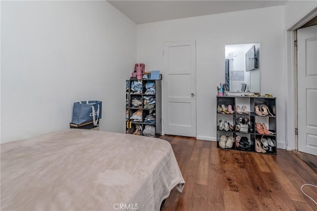 bedroom featuring dark hardwood / wood-style flooring