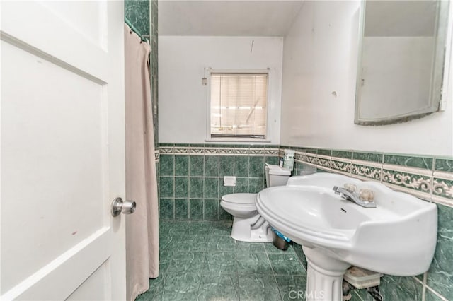 bathroom featuring sink, tile walls, toilet, and tile patterned flooring