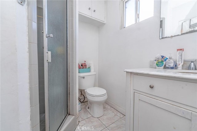 bathroom featuring a shower with shower door, toilet, and vanity