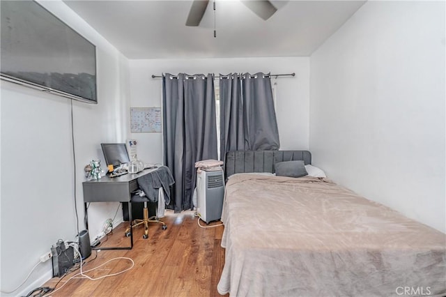 bedroom featuring ceiling fan and hardwood / wood-style flooring