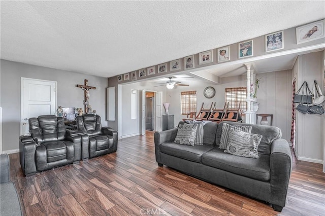 living room with ceiling fan, a textured ceiling, and hardwood / wood-style floors