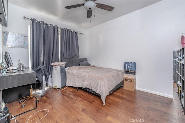 bedroom featuring ceiling fan and dark hardwood / wood-style flooring