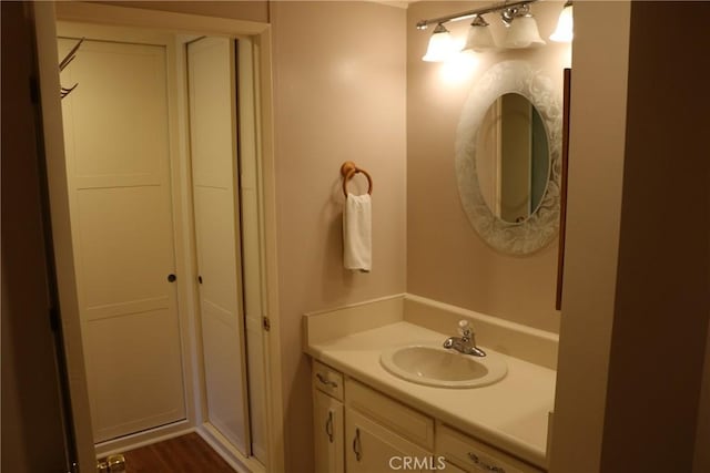 bathroom with hardwood / wood-style floors and vanity