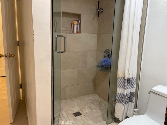 bathroom with curtained shower and toilet