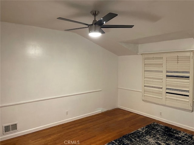 spare room with dark hardwood / wood-style flooring, lofted ceiling, and ceiling fan