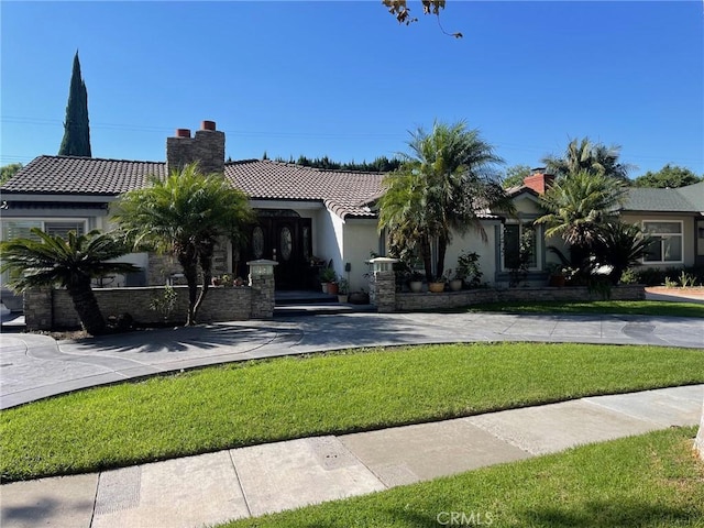 mediterranean / spanish house featuring a front yard