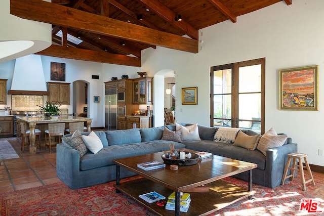 tiled living room featuring french doors, beam ceiling, high vaulted ceiling, and wooden ceiling