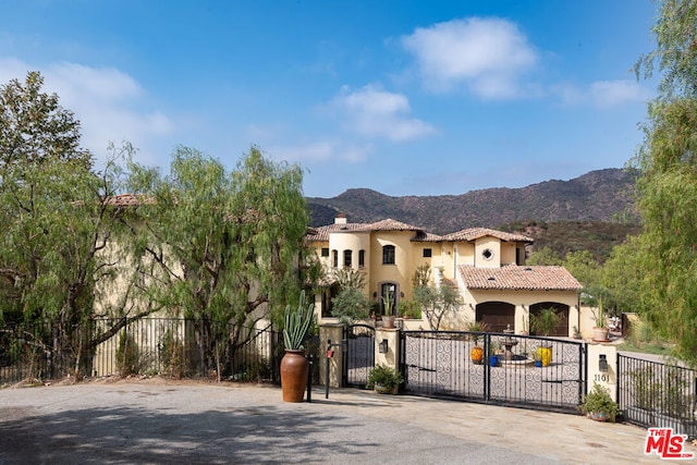 mediterranean / spanish house with a mountain view and a garage