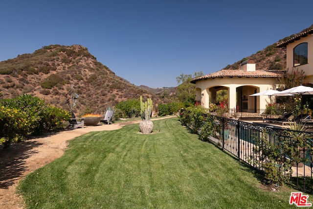 view of yard featuring a mountain view and a patio