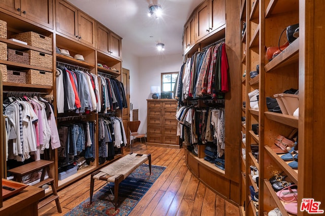 spacious closet with light hardwood / wood-style flooring