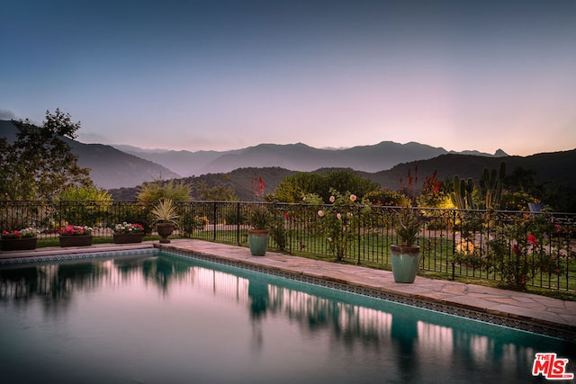 pool at dusk with a mountain view